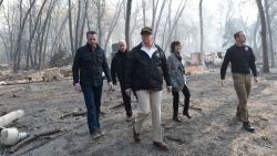 US President Donald Trump (C) walks with Paradise Mayor Jody Jones (2R), Governor of California Jerry Brown (2L), Administrator of the Federal Emergency Management Agency, Brock Long (R), and Lieutenant Governor of California, Gavin Newson, as they view damage from wildfires in Paradise, California on November 17, 2018. - President Donald Trump arrived in California to meet with officials, victims and the "unbelievably brave" firefighters there, as more than 1,000 people remain listed as missing in the worst-ever wildfire to hit the US state. (Photo by SAUL LOEB / AFP)        (Photo credit should read SAUL LOEB/AFP/Getty Images)