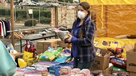 Volunteers provide evacuees with supplies from smoke masks to food.