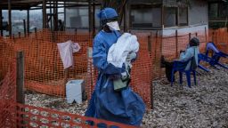 TOPSHOT - A health worker carries a four-day-old baby suspected of having Ebola, into a MSF (Doctors Without Borders) supported Ebola Treatment Centre (ETC) on November 4, 2018 in Butembo, Democratic Republic of the Congo. - The death toll from an Ebola outbreak in eastern Democratic Republic of Congo has risen to more than 200, the health ministry said on November 10, 2018. (Photo by John WESSELS / AFP)        (Photo credit should read JOHN WESSELS/AFP/Getty Images)