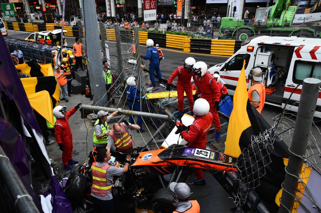 Race personnel and pit crew at the accident site after Sophia Floersch's crash.