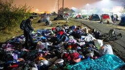 TOPSHOT - Evacuees sift through a pile of clothing at an evacuee encampment in a Walmart parking lot in Chico, California on November 17, 2018. - More than 1,000 people remain listed as missing in the worst-ever wildfire to hit the US state. (Photo by Josh Edelson / AFP)        (Photo credit should read JOSH EDELSON/AFP/Getty Images)