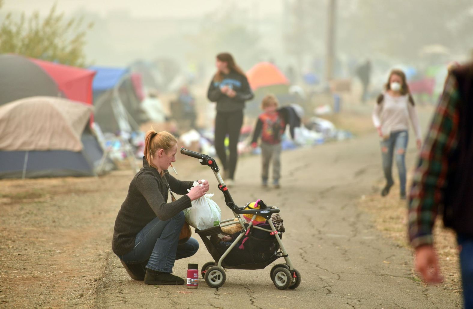 Ashley Sheppard, whose house burned down, tends to her baby on November 15.