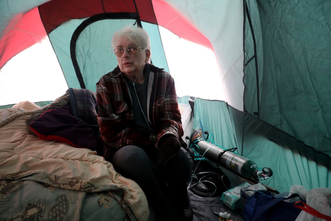 Jackie Wineland, 74, uses her oxygen tank in a tent on Tuesday, November 13.
