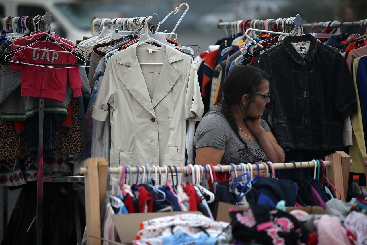An evacuee looks through donated clothing at the makeshift evacuation shelter on November 16.