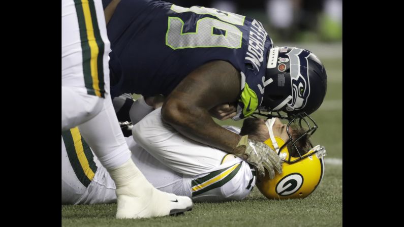 Green Bay Packers quarterback Aaron Rodgers is sacked by Seattle Seahawks defensive end Quinton Jefferson during the first half of an NFL game on Thursday, November 15, in Seattle, Washington.