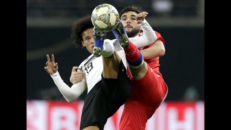 Germany's Leroy Sane, left, and Russia's Kirill Nababkin challenge for the ball during a friendly soccer match between Germany and Russia in Leipzig, Germany, Thursday, November 15.