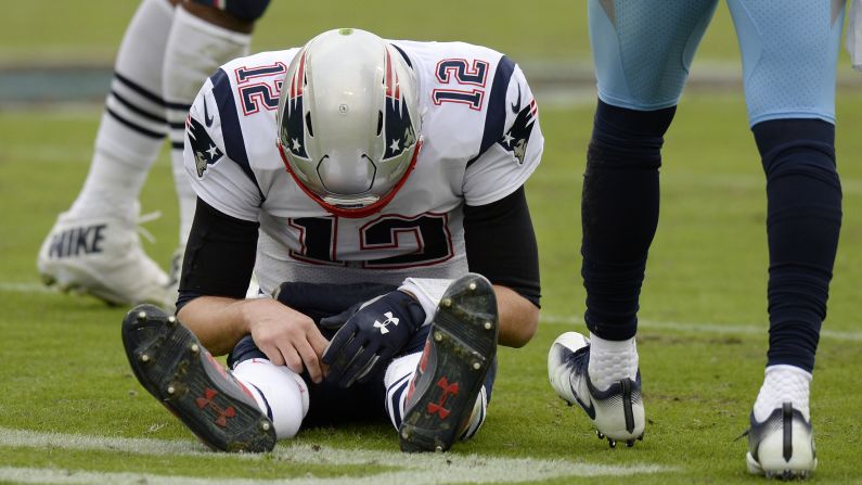 New England Patriots quarterback Tom Brady sits on the turf after being sacked in the second half their game against the Tennessee Titans on Sunday, November 11 in Nashville, Tennessee.