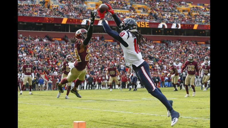 Houston Texans wide receiver DeAndre Hopkins pulls in a touchdown pass while being defended by Washington Redskins cornerback Josh Norman during the first half of their game on Sunday, November 18 in Landover, Maryland.