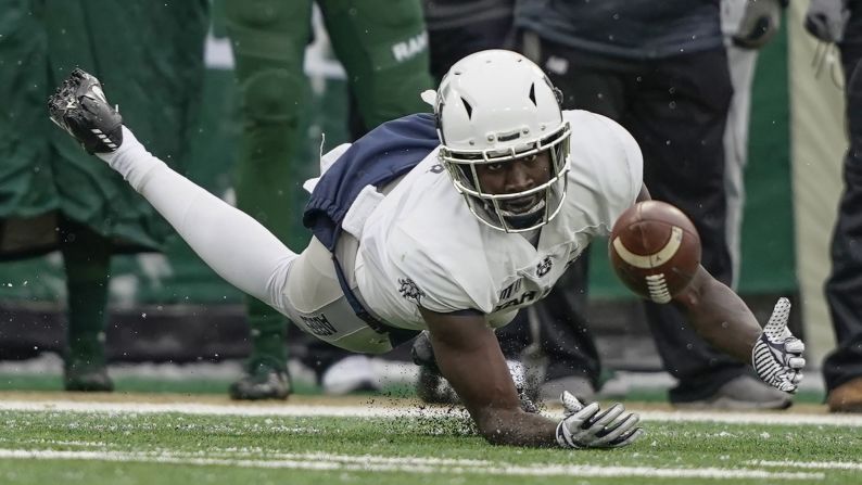 Utah State wide receiver Ron'quavion Tarver attempts to catch a pass during the first half of an NCAA football game against Colorado State on November 17 in Fort Collins, Colorado.