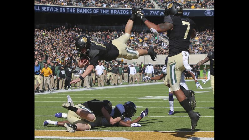 Baylor quarterback Charlie Brewer dives over the goal line for a touchdown in the first half of an NCAA football game against TCU on November 17 in Waco, Texas.