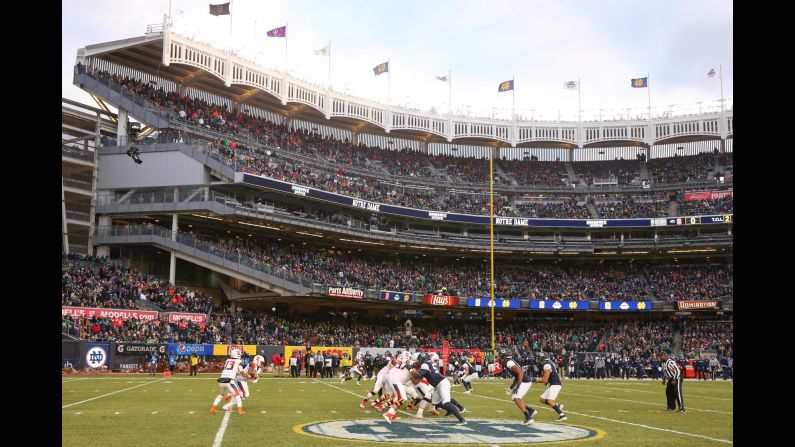 Syracuse Orange quarterback Tommy DeVito hands the ball off to running back Dontae Strickland during a game against the Notre Dame Fighting Irish at Yankee Stadium in New York, on November 17.