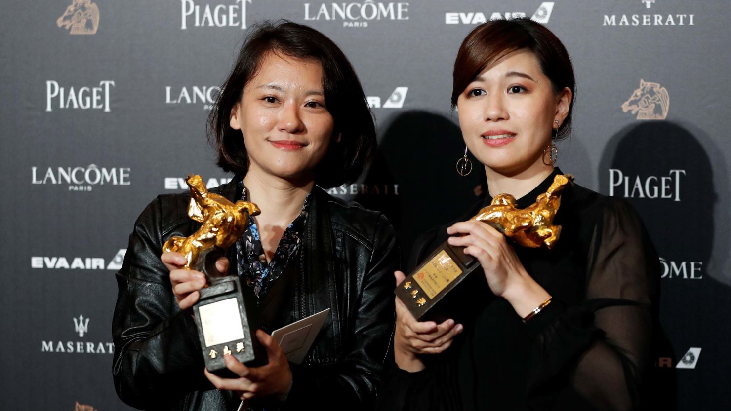 Taiwanese director Fu Yue (R) poses backstage after winning Best Documentary for her movie "Our Youth in Taiwan" at the 55th Golden Horse Awards in Taipei on?November 17, 2018.