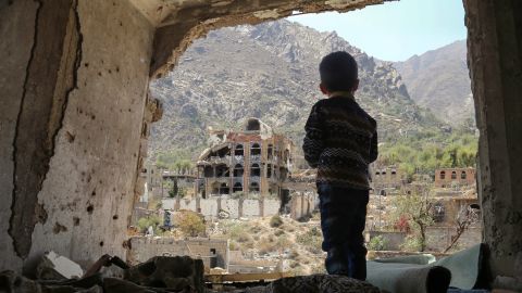 TOPSHOT - A photo taken on March 18, 2018, shows a Yemeni child looking out at buildings that were damaged in an air strike in the southern Yemeni city of Taez. / AFP PHOTO / Ahmad AL-BASHA (Photo credit should read AHMAD AL-BASHA/AFP/Getty Images)