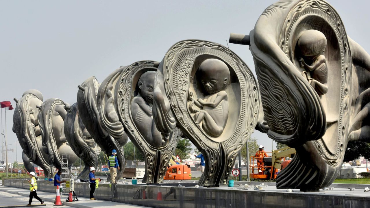 Workers operate on "The Miraculous Journey", an art installation by artist Damien Hirst outside the Sidra Medical & Research Centre in Qatar's capital Doha, on the day of their unveiling on October 10, 2018. - Fourteen giant bronze sculptures by British artist Damien Hirst graphically documenting the moment from conception to birth have been officially unveiled outside a new hospital in Qatar. "The Miraculous Journey", which culminates with a 14-metre (46-feet) statue of a just-born naked baby, is the eye-catching centrepiece of 65 separate works at Doha's Sidra Medicine Hospital, forming possibly the largest collection of art at any medical facility anywhere in the world. (Photo by STRINGER / AFP) / The erroneous mention[s] appearing in the metadata of this photo by - has been modified in AFP systems in the following manner: [October 10] instead of [November 18]. Please immediately remove the erroneous mention[s] from all your online services and delete it (them) from your servers. If you have been authorized by AFP to distribute it (them) to third parties, please ensure that the same actions are carried out by them. Failure to promptly comply with these instructions will entail liability on your part for any continued or post notification usage. Therefore we thank you very much for all your attention and prompt action. We are sorry for the inconvenience this notification may cause and remain at your disposal for any further information you may require.        (Photo credit should read STRINGER/AFP/Getty Images)