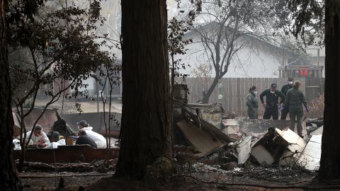  Sheriff deputies and rescue workers recover human remains from a home destroyed by the Camp Fire. 