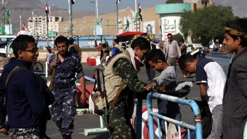 Houthi fighters check people entering a square for a rally last month in Sanaa.