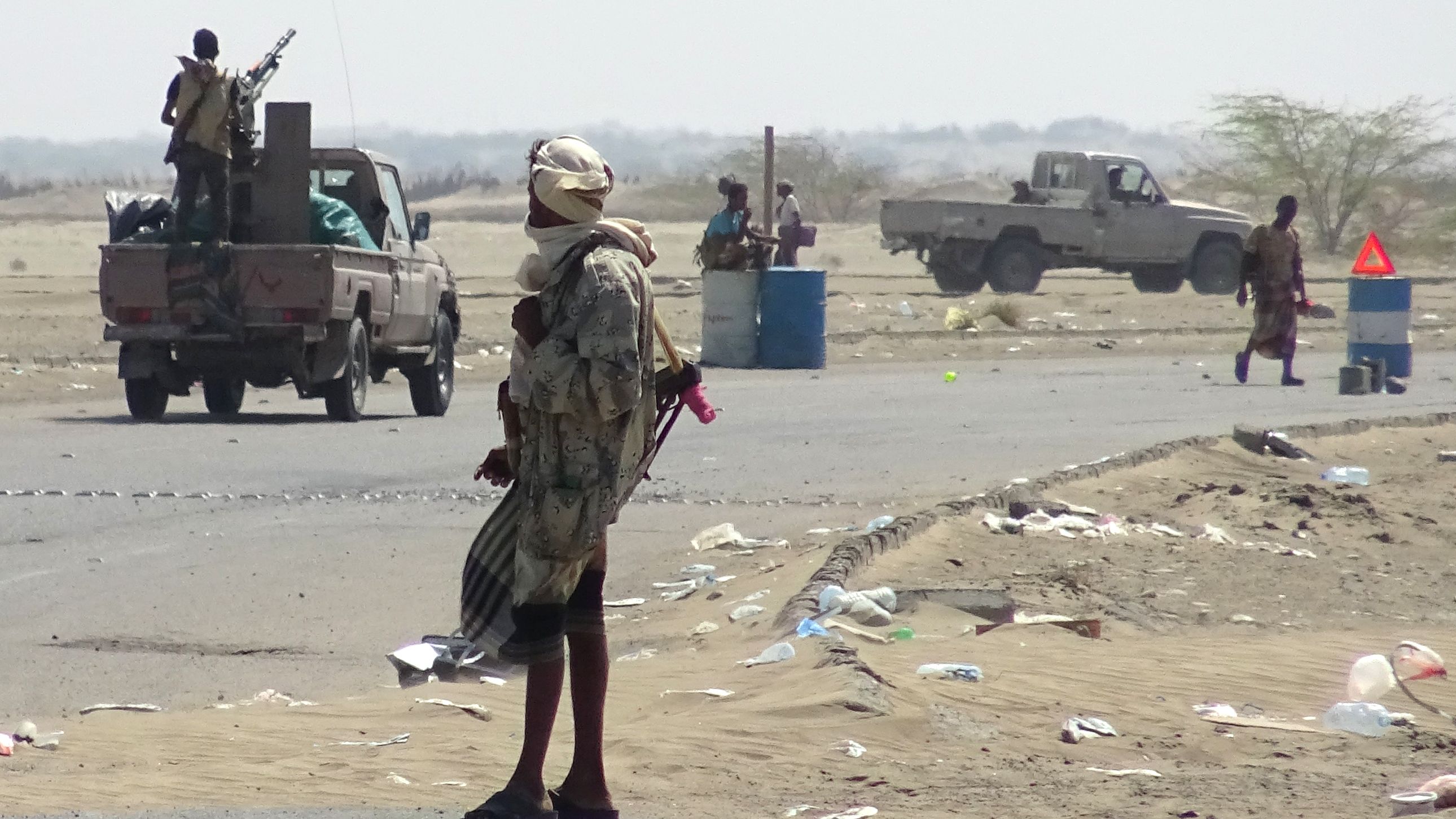 Yemeni pro-government forces gather at a checkpoint in a street on the eastern outskirts of Hodeidah. 