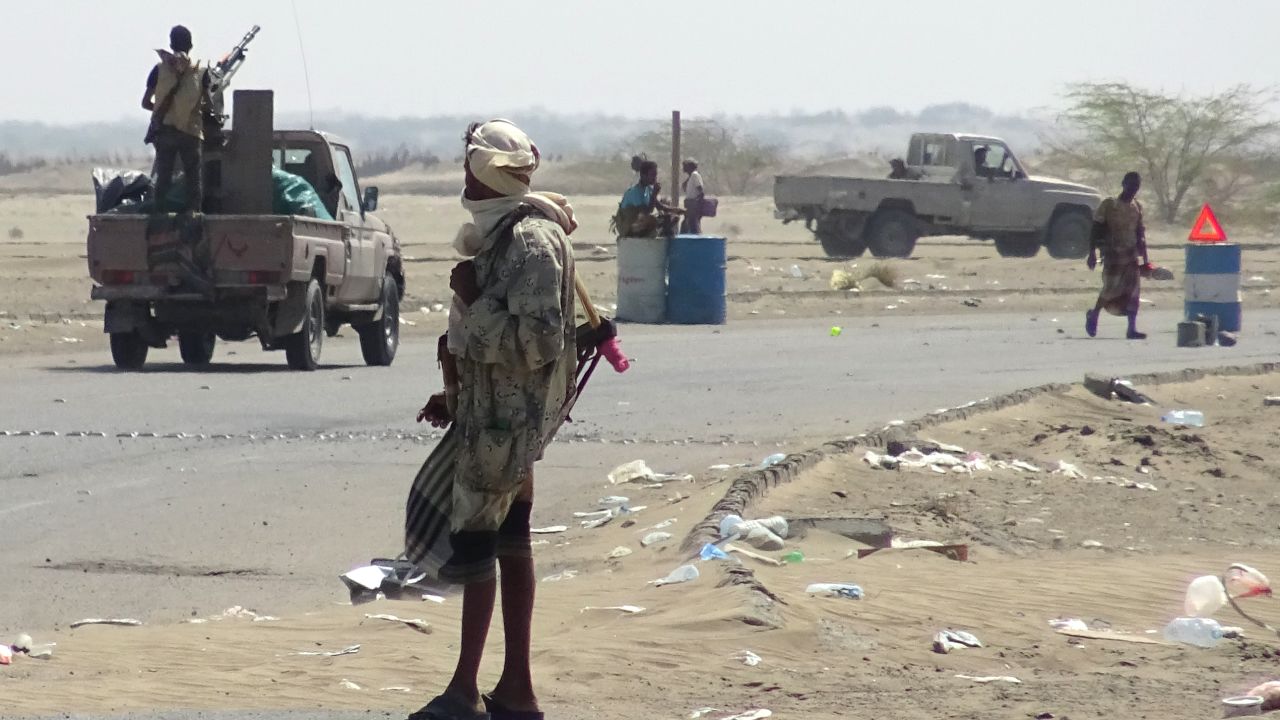 Yemeni pro-government forces gather at a checkpoint in a street on the eastern outskirts of Hodeidah.