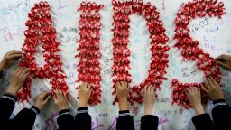 Chinese students use handmade red ribbons to form "AIDS" one day ahead of the the World AIDS Day, at a school in Hanshan, east China's Anhui province on November 30, 2009. China warned in a notice for  World AIDS Day that homosexual transmission of the disease was gaining pace and called for health authorities nationwide to step up prevention work. China's health ministry estimates that at the end of 2009, 740,000 people were living with HIV in the country of 1.3 billion, and the latest data shows that 48,000 were infected this year, according to UNAIDS.  CHINA OUT AFP PHOTO / AFP / STR        (Photo credit should read STR/AFP/Getty Images)
