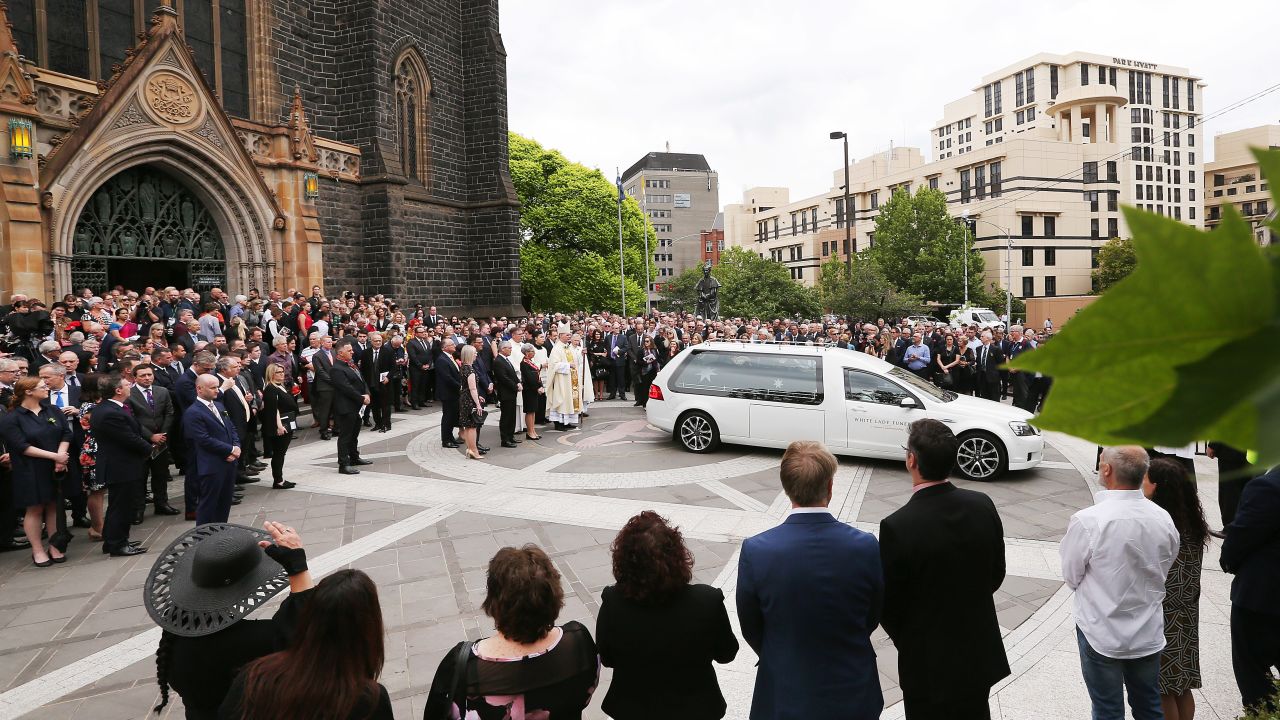 The hearse carrying the body of Sisto Malaspina leaves during the state funeral for Sisto Malaspina at St. Patrick's Cathedral on Tuesday in Melbourne.