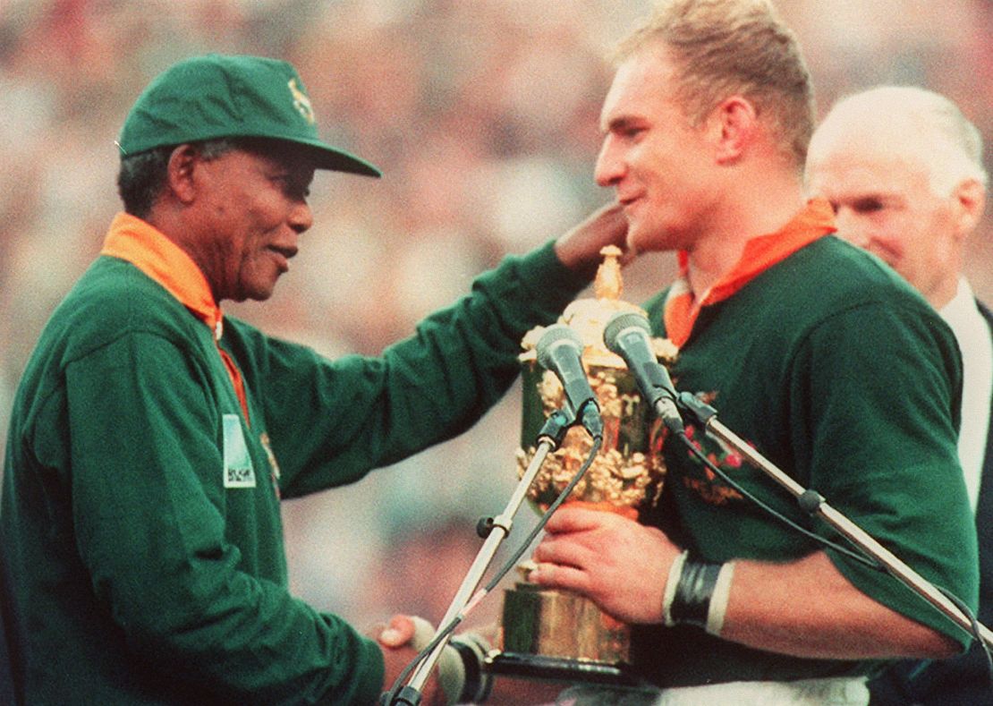 South African rugby team captain, Francois Pienaar (R), is congratulated by South African President Nelson Mandela (L) after South Africa won the Rugby World Cup final against New Zealand 24 June 1995.