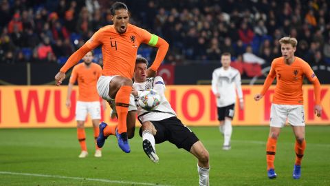 Dutch captain Virgil van Dijk battles for possession with Thomas Muller of Germany during their UEFA Nations League A1 match.