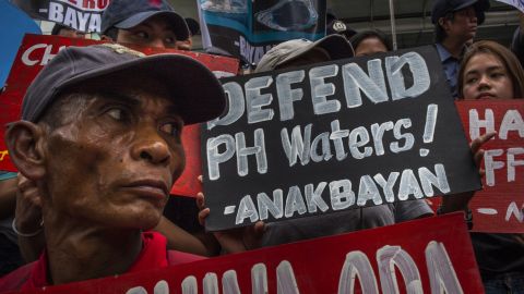 Demonstrators carry placards bearing anti-China slogans in a protest of Chinese influence in the Asia-Pacific sphere.