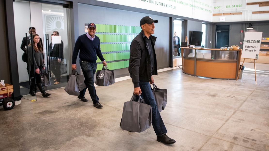 Obama carries donated food on Tuesday to the Greater Chicago Food Depository.