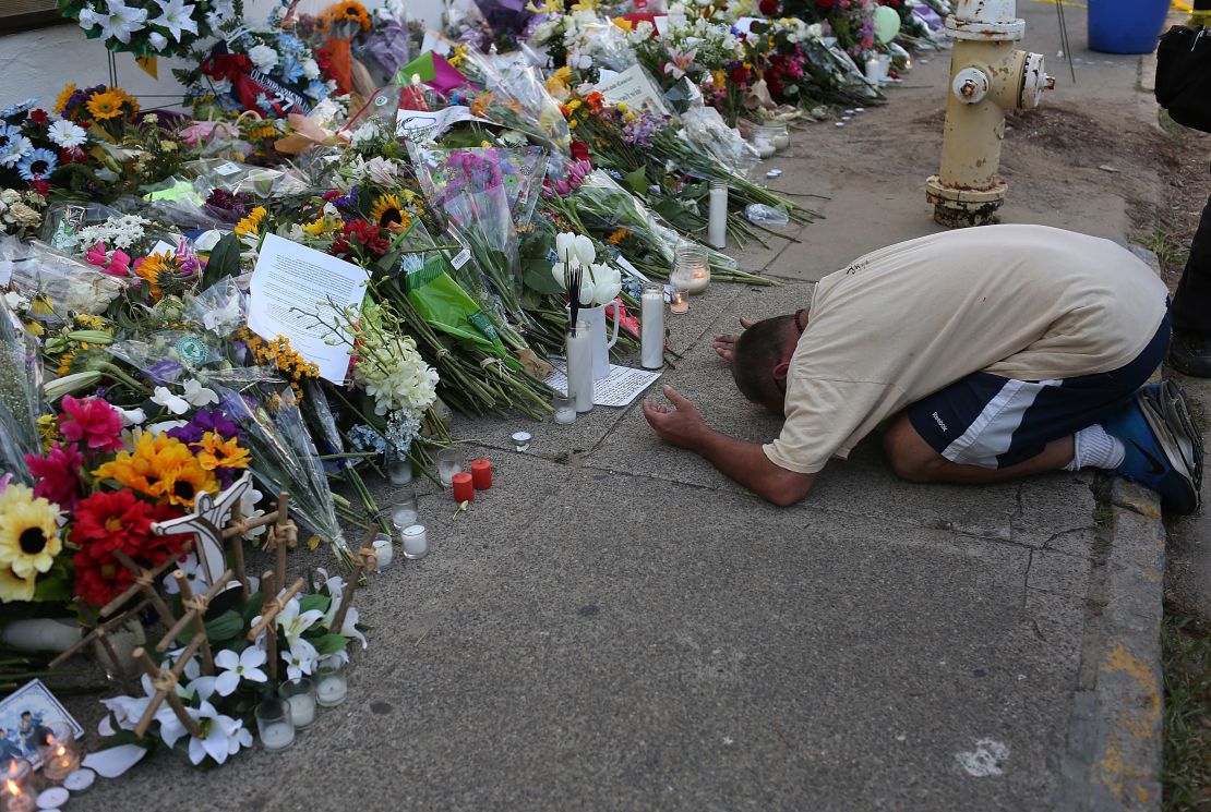 A man prays at a memorial to the Charleston victims.