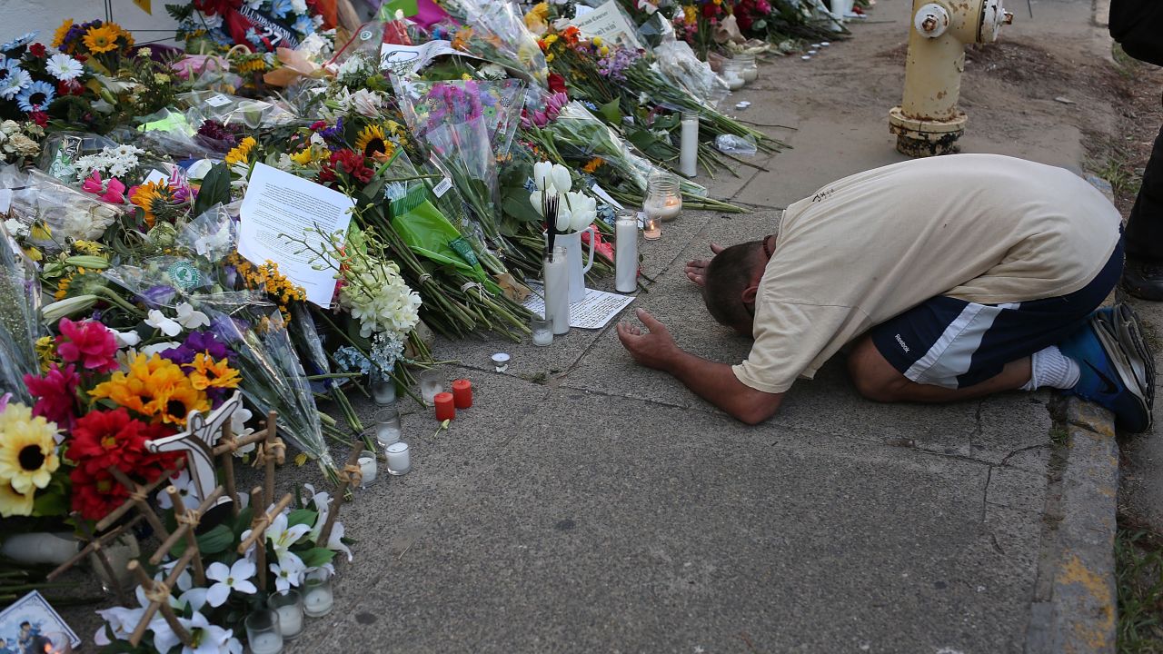 A man prays at a memorial to the Charleston victims.