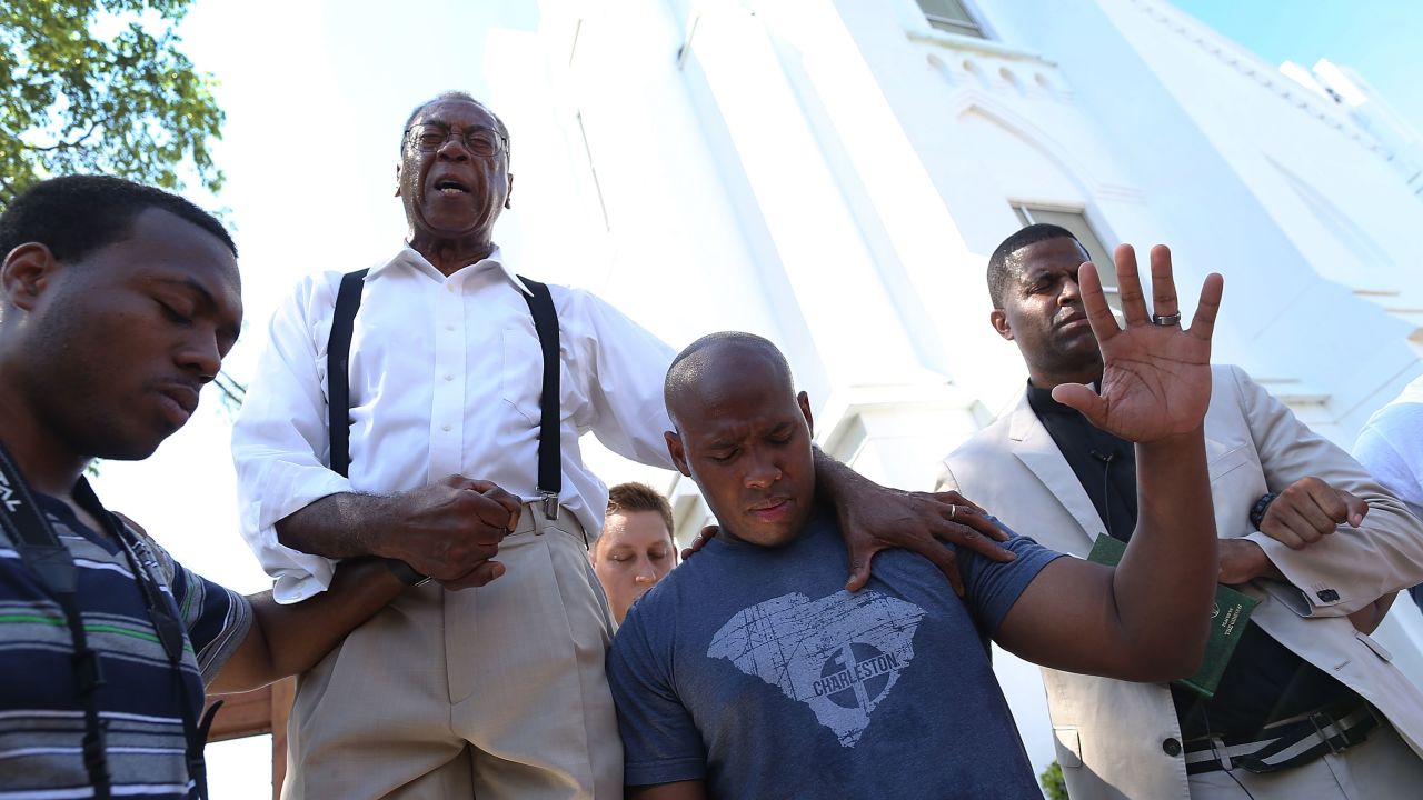 A pastor leads a group in emotional prayer after the masscare inside a Charleston church.