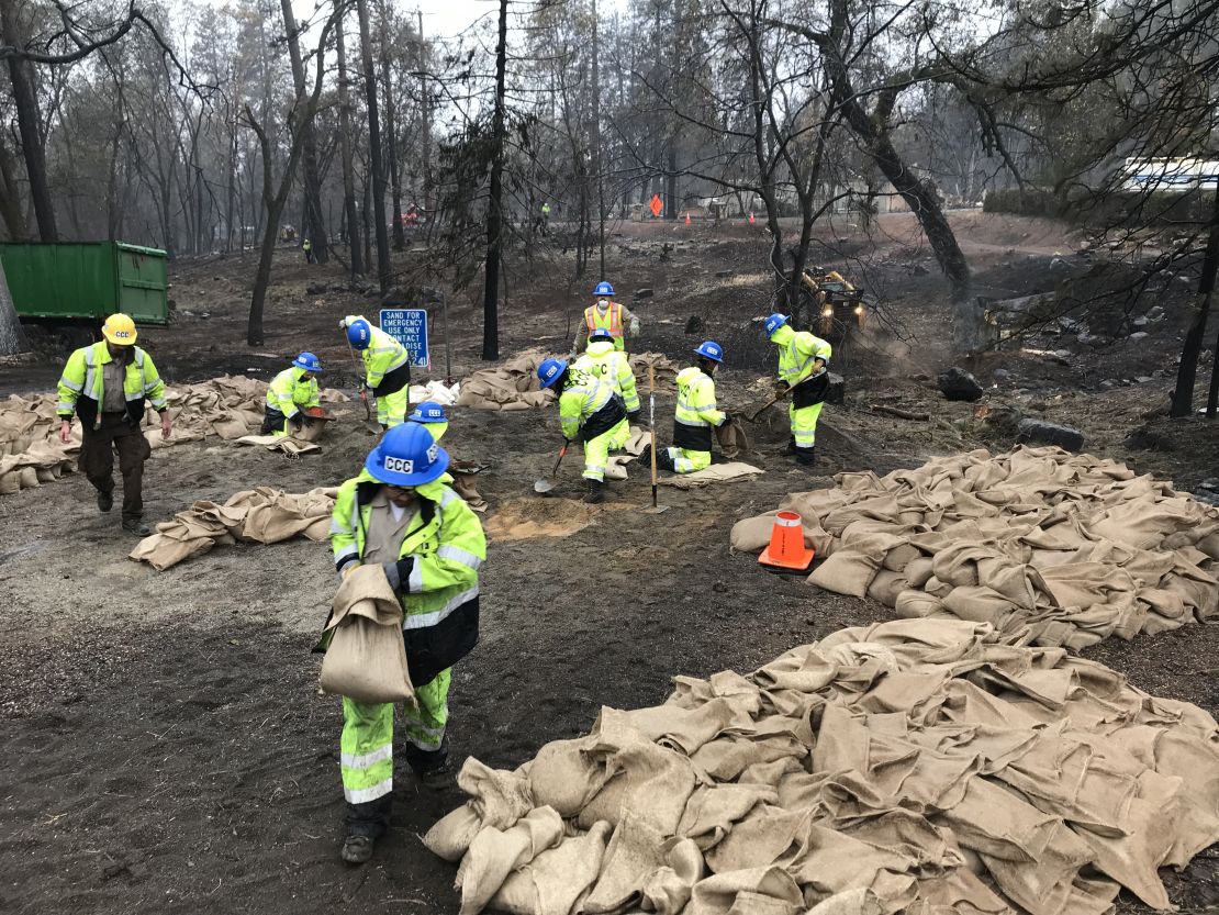 California Conservation Corps members fill out sandbags ahead of significant rain.