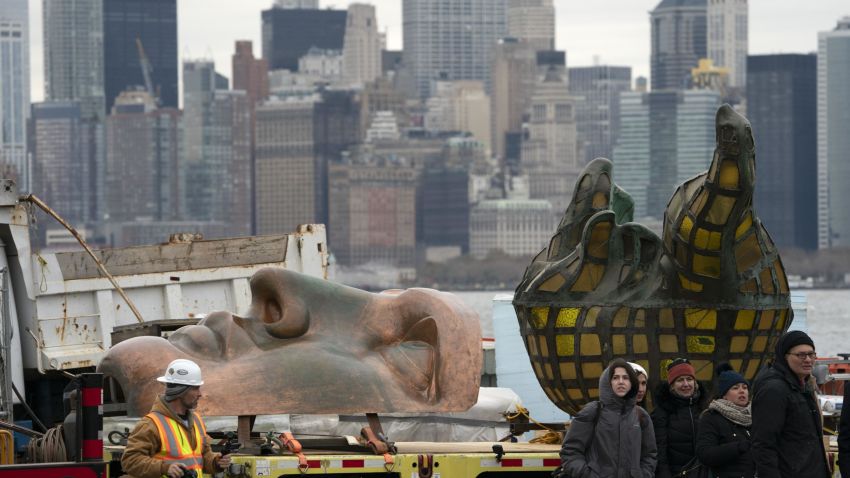 Workers transport the Statue of Liberty original torch along with a replica of the statue's face to its permanent home in the new Statue of Liberty Museum November 15, 2018 in New York City. (Photo by Don EMMERT / AFP)        (Photo credit should read DON EMMERT/AFP/Getty Images)