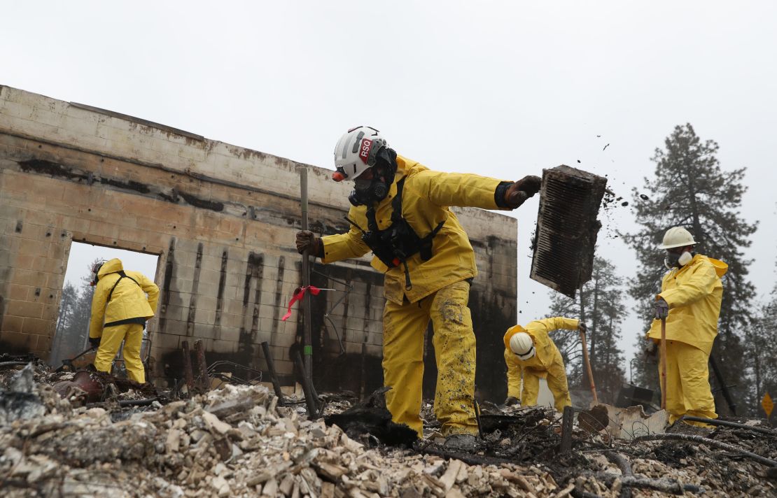Crews dig through a gutted   business this week in search of human remains in Paradise, California. 