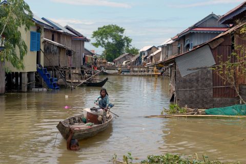 Communities living on the river are vulnerable to flooding, particularly during the monsoon season. In 2013, floods in Cambodia left more than 80 dead and wreaked havoc in villages like this one in Kandal province.<br />