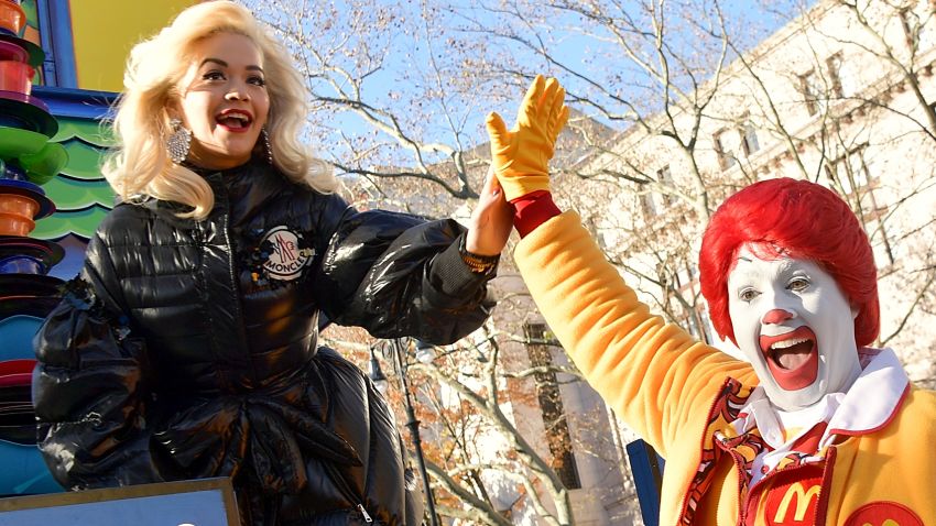 NEW YORK, NY - NOVEMBER 22:  Singer Rita Ora high fives with Ronald McDonald during the the 2018 Macy's Thanksgiving Day Parade on November 22, 2018 in New York City.  (Photo by Michael Loccisano/Getty Images)