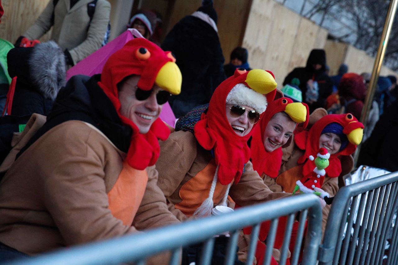 People don turkey hats to keep warm along the parade route.