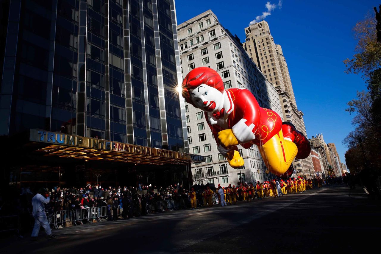 A Ronald McDonald balloon passes by a building on Central Park West. 