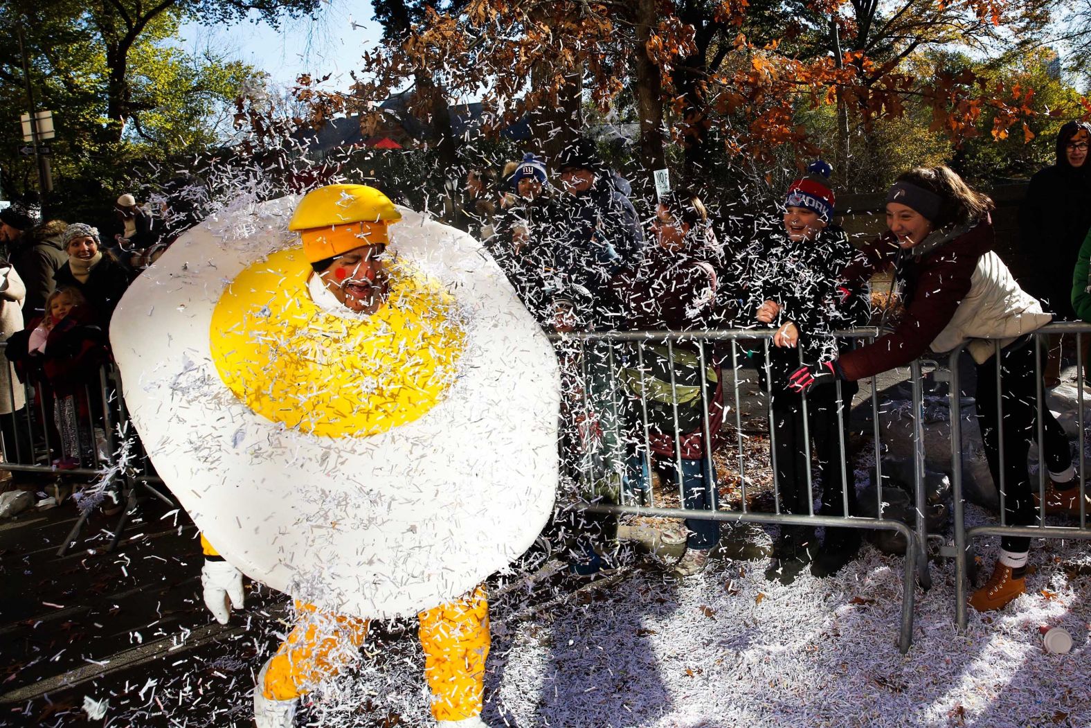 A parade performer is showered in confetti.