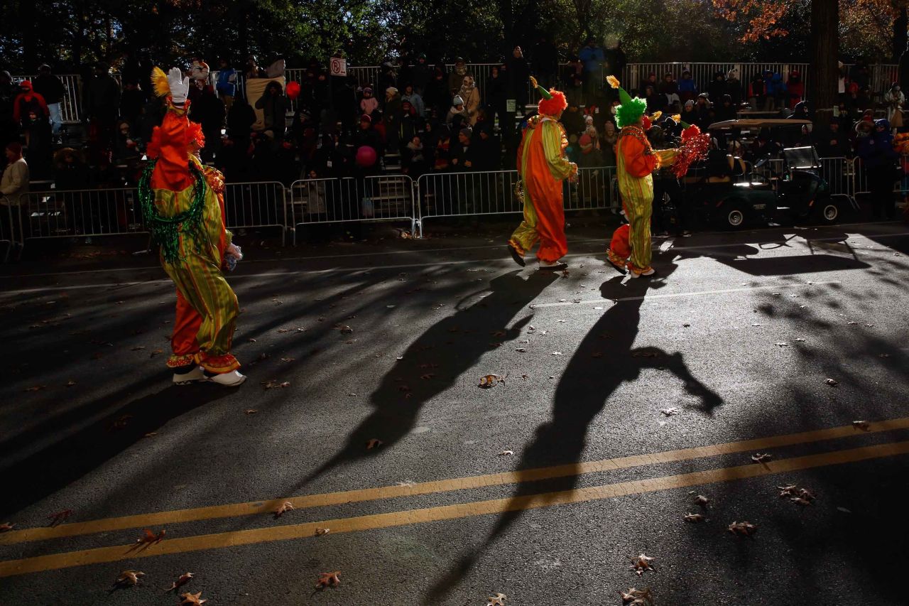 Clowns have some fun along the parade route.
