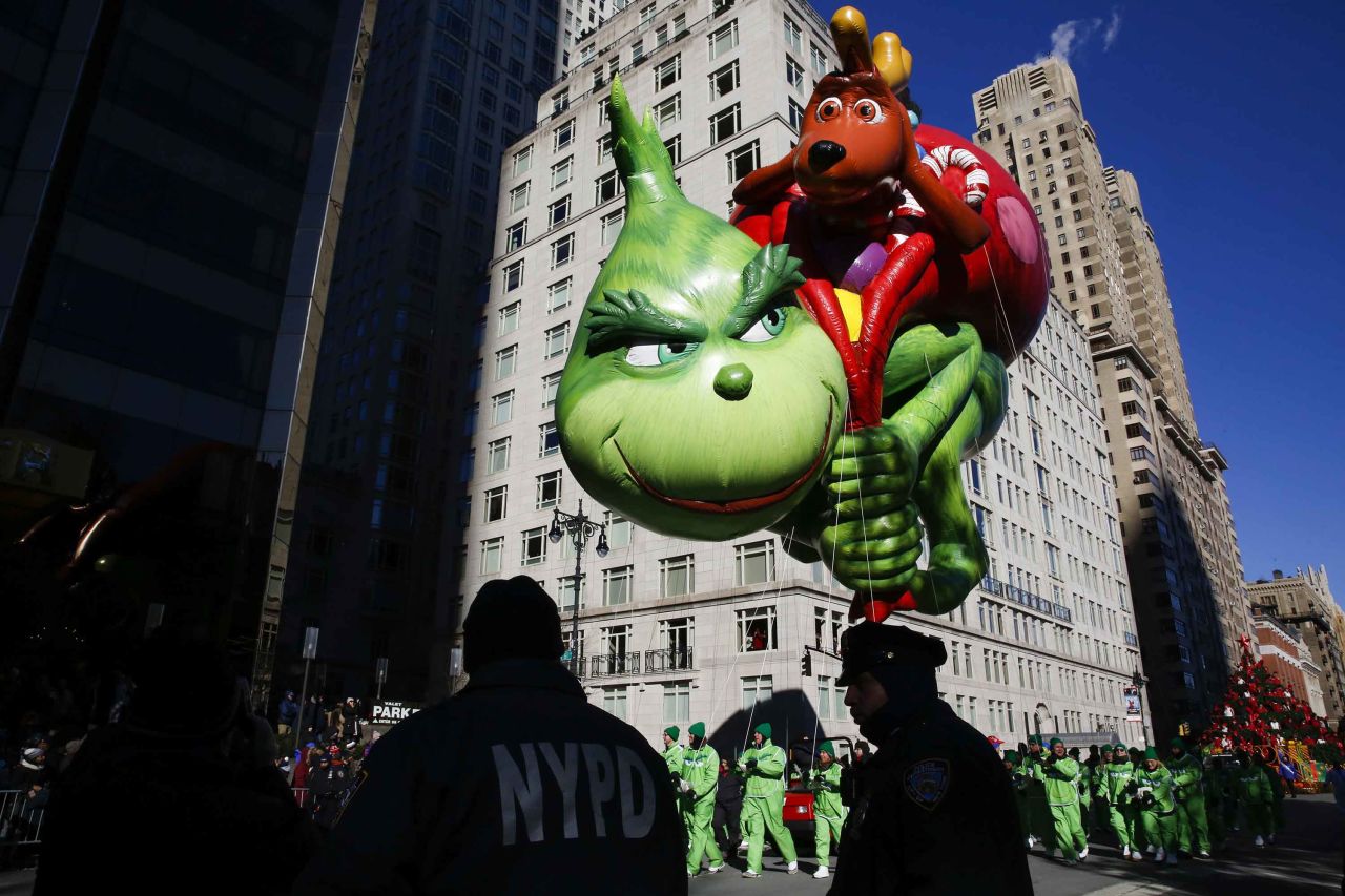 The Grinch balloon floats over Central Park West.