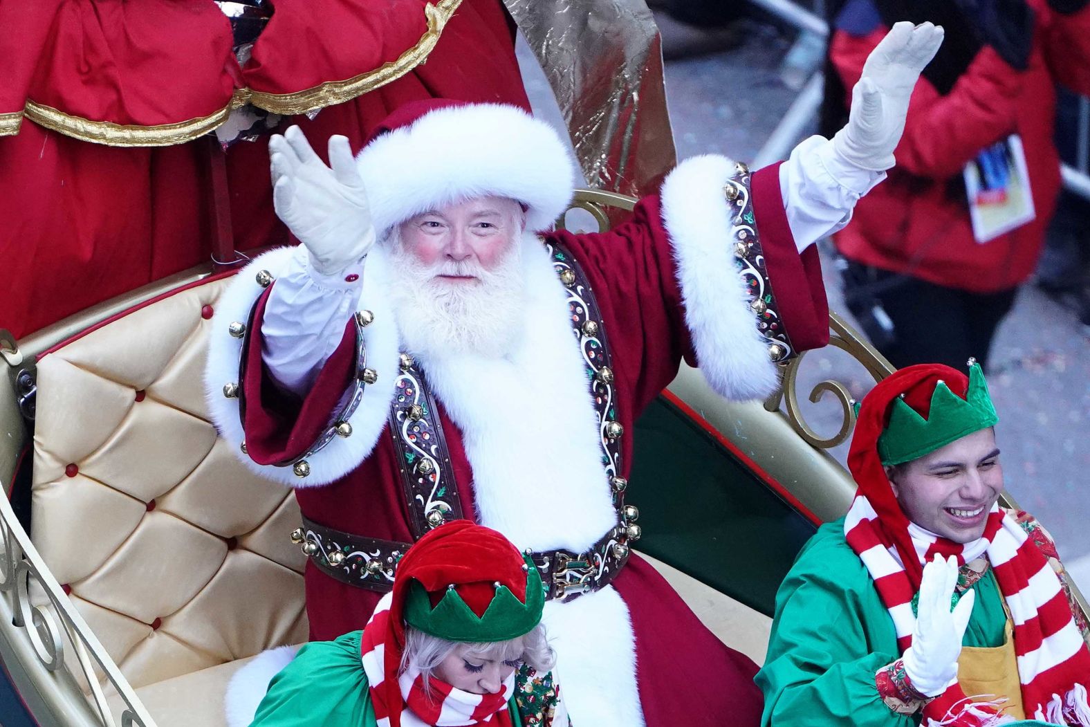 Santa Claus waves from his sleigh.
