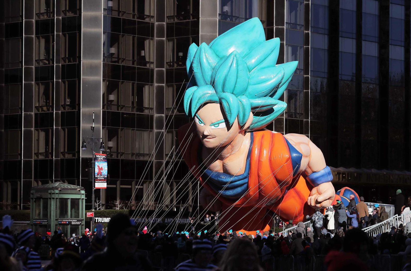 A Goku float from the "Dragon Ball" anime series makes its way through the street.