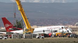 Workers at El Alto International Airport in Bolivia try to tow a Peruvian Airlines plane after it skidded and fell on one side during an incident during landing. 
