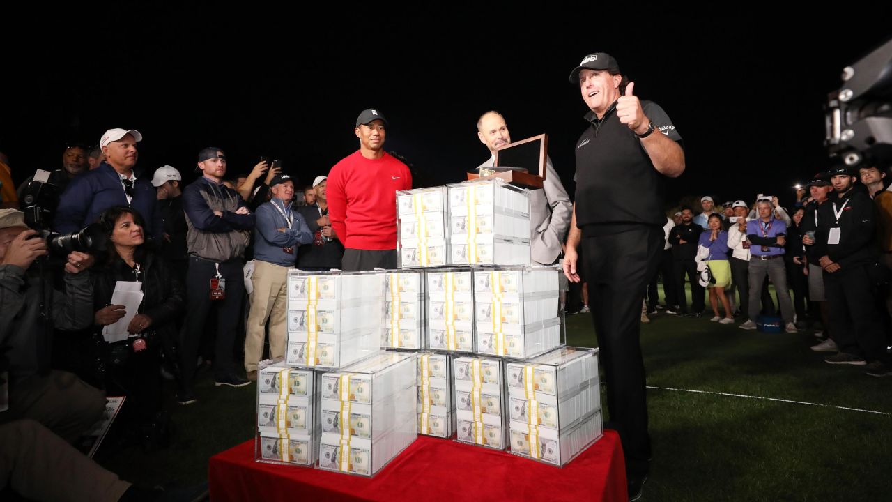Phil Mickelson with his $9 million after defeating Tiger Woods.
