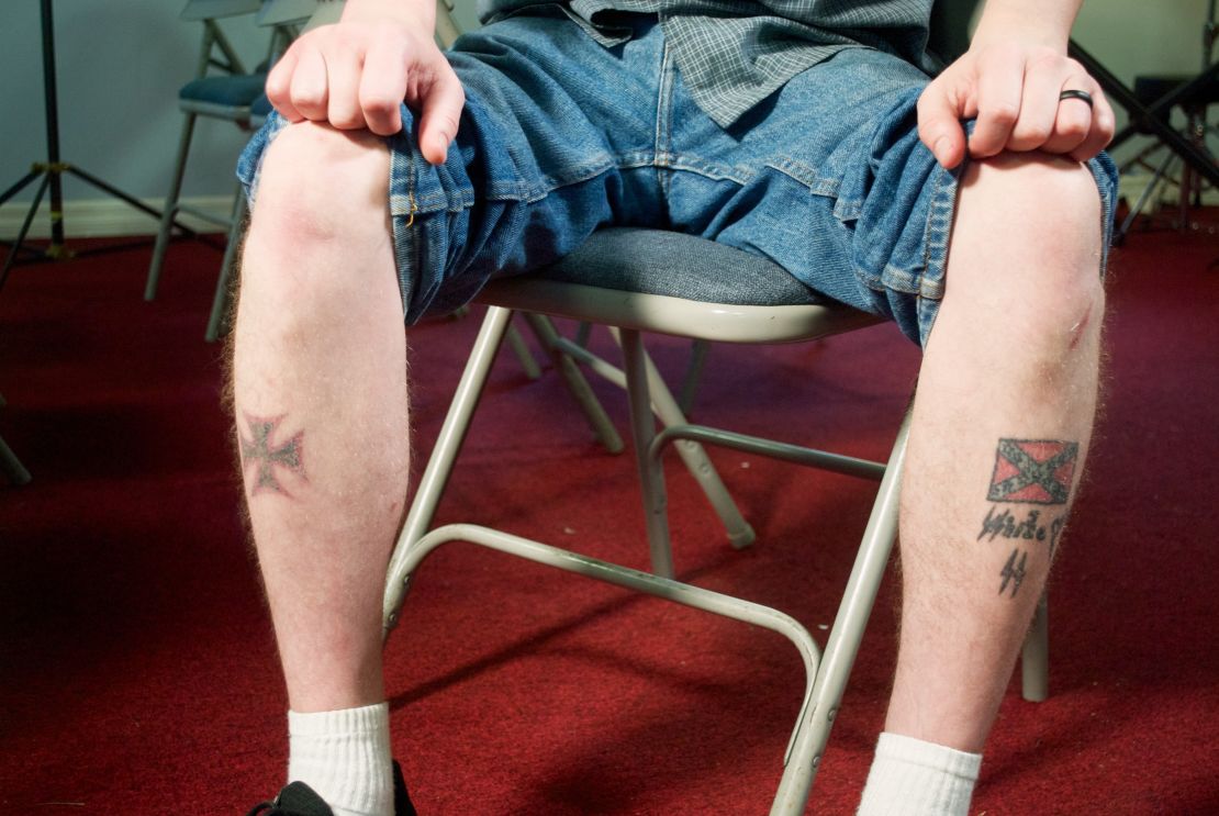 Ken Parker shows the tattoos of a German Iron Cross, a Confederate flag  and Nazi lightning bolts.