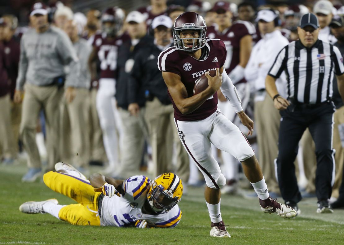 Texas A&M quarterback Kellen Mond slips the tackle attempt by LSU's JaCoby Stevens in the first half.