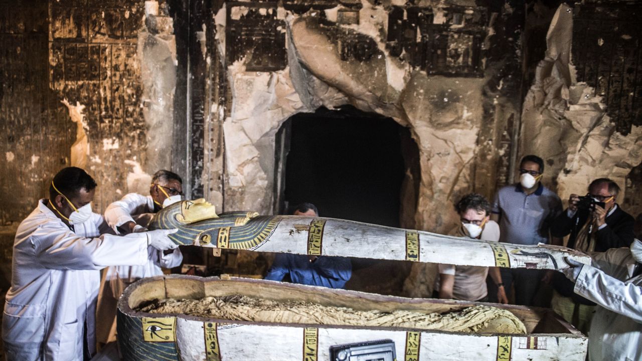 Egypt's Antiquities Minister Khaled el-Enany (2nd-R) and Mostafa Waziri (C, behind), the Secretary General of the Supreme Council of Antiquities, inspect an intact sarcophagus during its opening at the site of Tomb TT33 at Al-Assasif necropolis on the west bank of the Nile north of the southern Egyptian city of Luxor on November 24, 2018, after it was discovered earlier this month by a French mission. - Located between the royal tombs at the Valley of the Queens and the Valley of the Kings, the Al-Assasif necropolis is the burial site of nobles and senior officials close to the pharaohs. (Photo by Khaled DESOUKI / AFP)        (Photo credit should read KHALED DESOUKI/AFP/Getty Images)