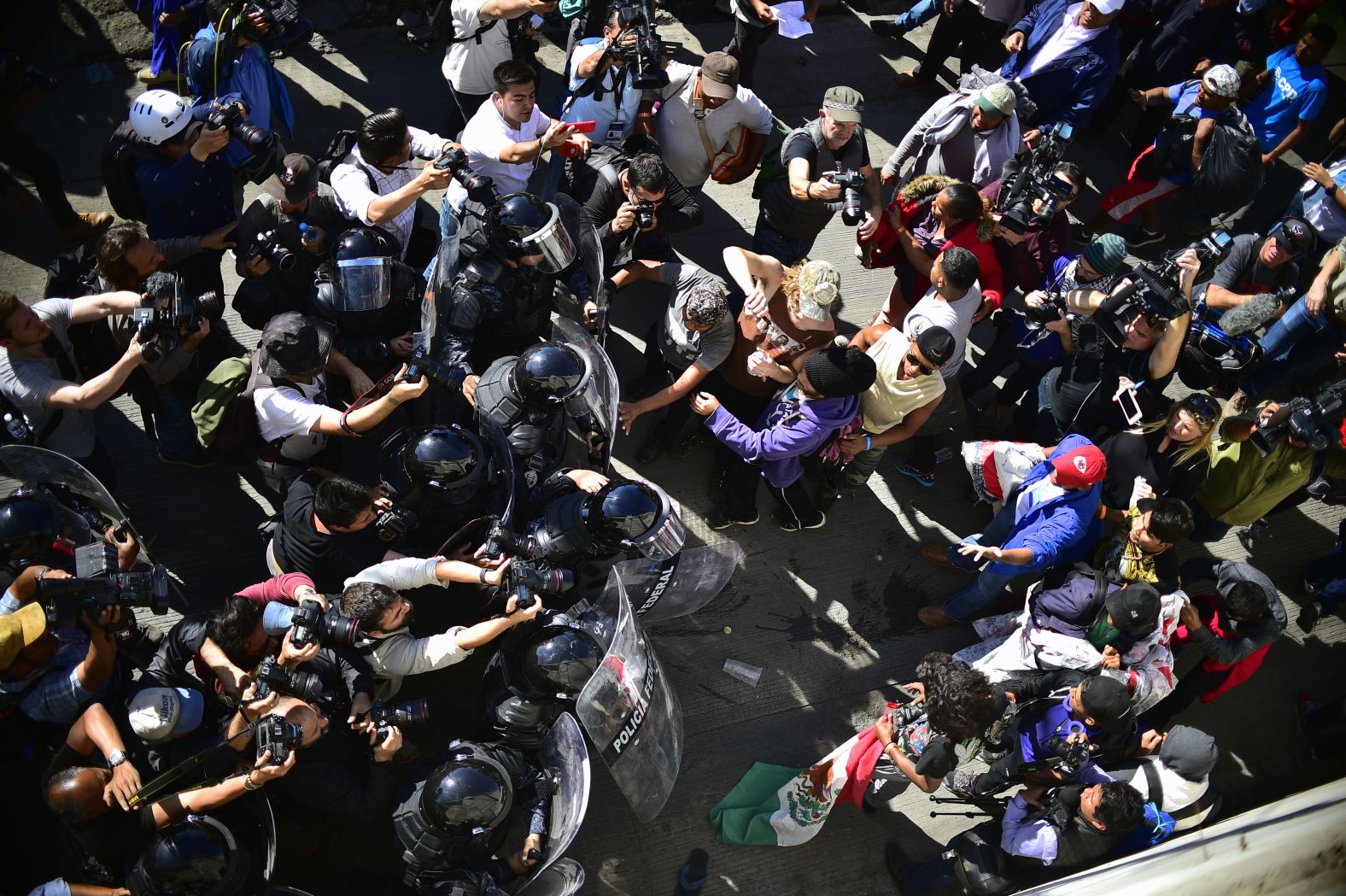 Migrants are stopped by Mexican police officers.