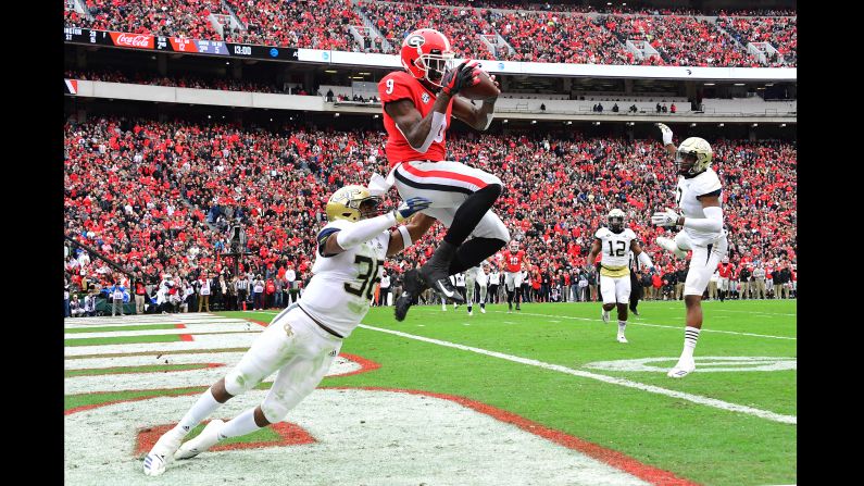 Jeremiah Holloman of the Georgia Bulldogs makes a catch for a second quarter touchdown against Malik Rivera of the Georgia Tech Yellow Jackets on Saturday, November 24 in Athens, Georgia. The Bulldogs beat the Yellow Jackets 45-21. 
